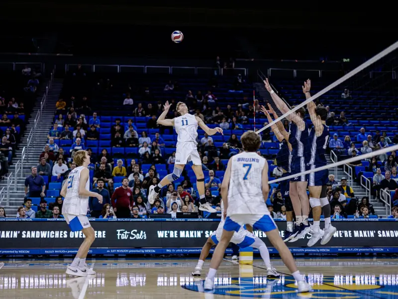 Cooper Robinson attacking for UCLA during an NCAA men's volleyball match.