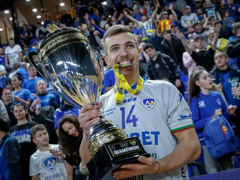 Damyan Kolev holding a championship trophy in a Levski Sofia jersey.