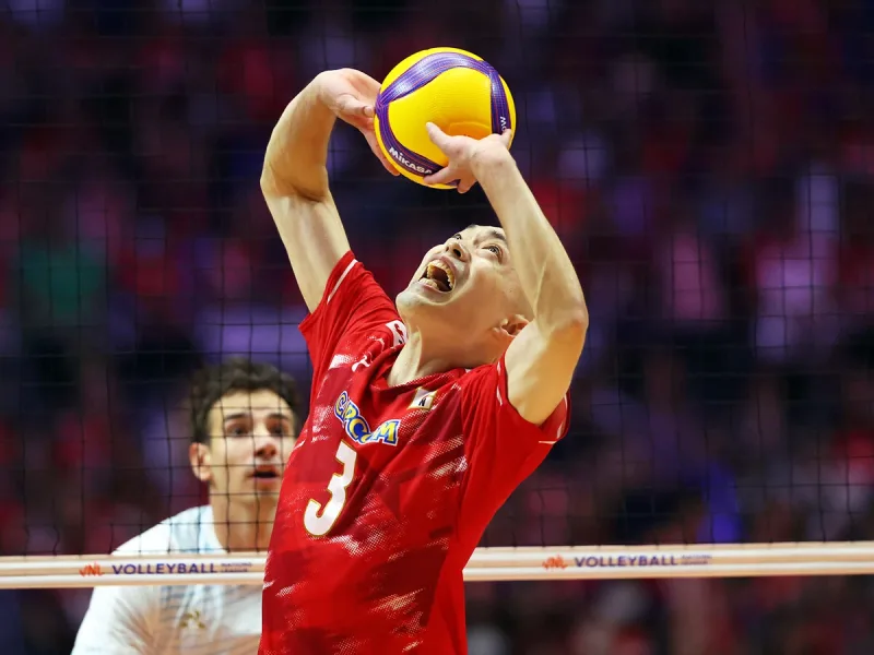 Hideomi Fukatsu setting the ball for Japan during international competition.