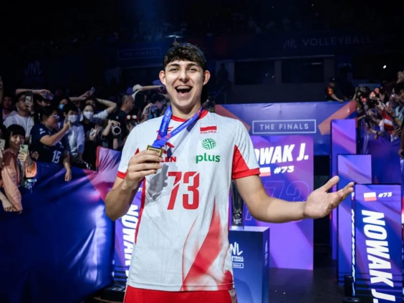 Jakub Nowak celebrates with a medal while representing Poland.