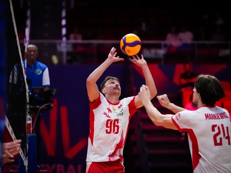 Jan Firlej sets the ball for Poland during international volleyball.