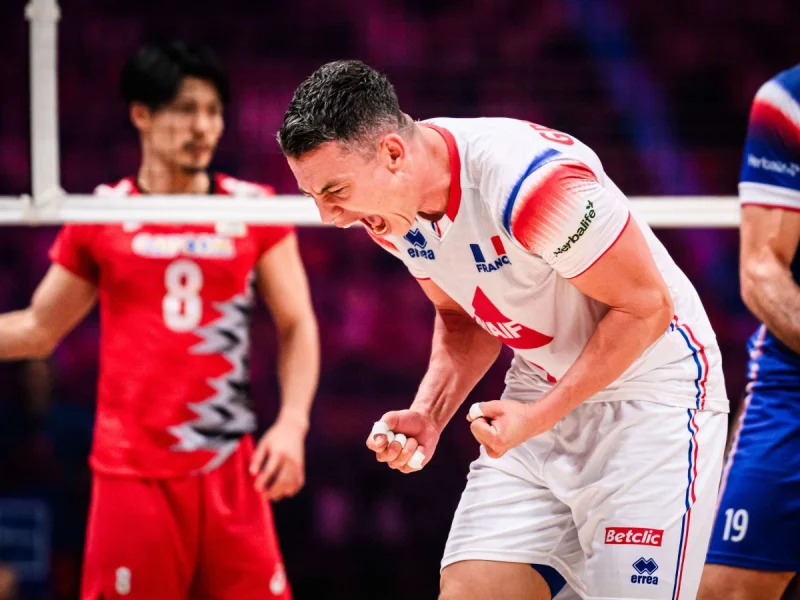 Jenia Grebennikov celebrates a point for France in a white national team jersey.