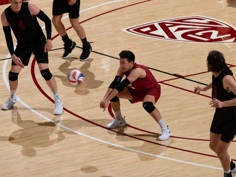 Justin Lui digging the ball for Stanford