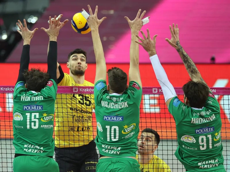 Kewin Sasak attacks for Bogdanka LUK Lublin against a block.