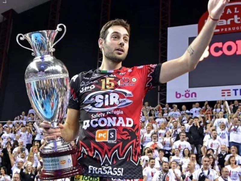 Luciano De Cecco holds a trophy while wearing Sir Safety Perugia colors.