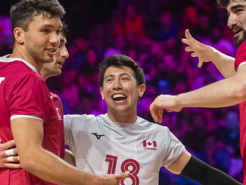 Max Elgert celebrating with teammates from the Canada men’s national volleyball team