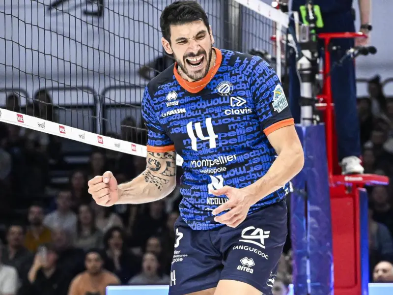 Nicolas Le Goff celebrates at the net in Montpellier Volley colors.