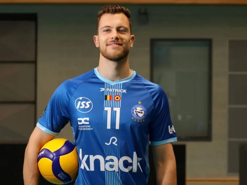 Seppe Van Hoyweghen posing in a Knack Roeselare jersey with a volleyball.