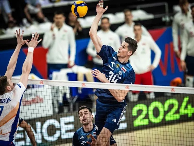 Szymon Jakubiszak attacks above the net for Poland during international volleyball.