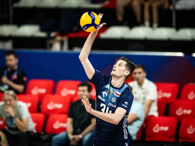 Szymon Jakubiszak serves for Poland during a Volleyball Nations League match.