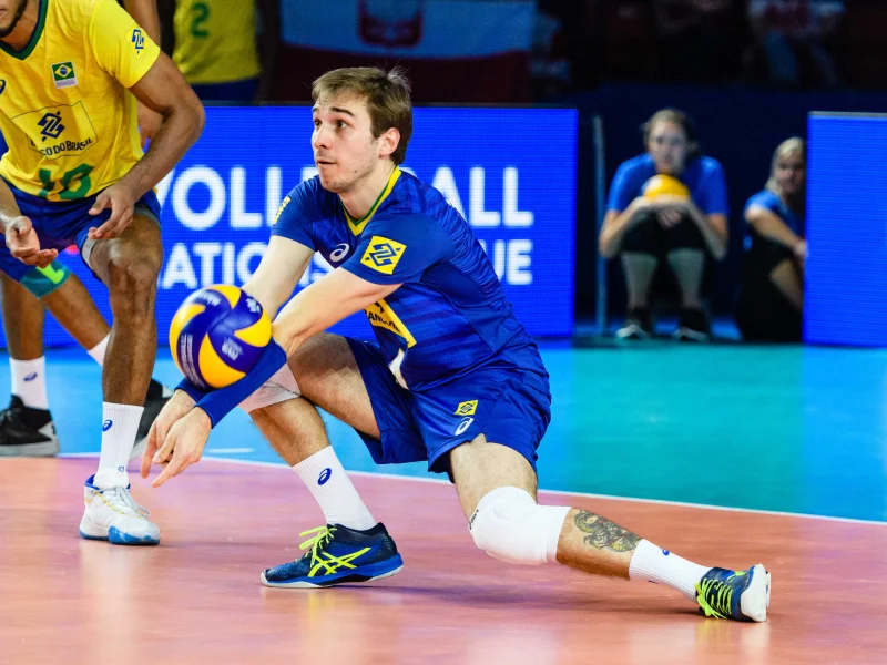 Thales Hoss lunges for a defensive dig while playing for Brazil.