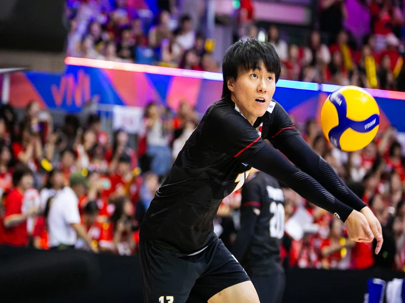 Tomohiro Ogawa receiving for Japan in international volleyball competition.