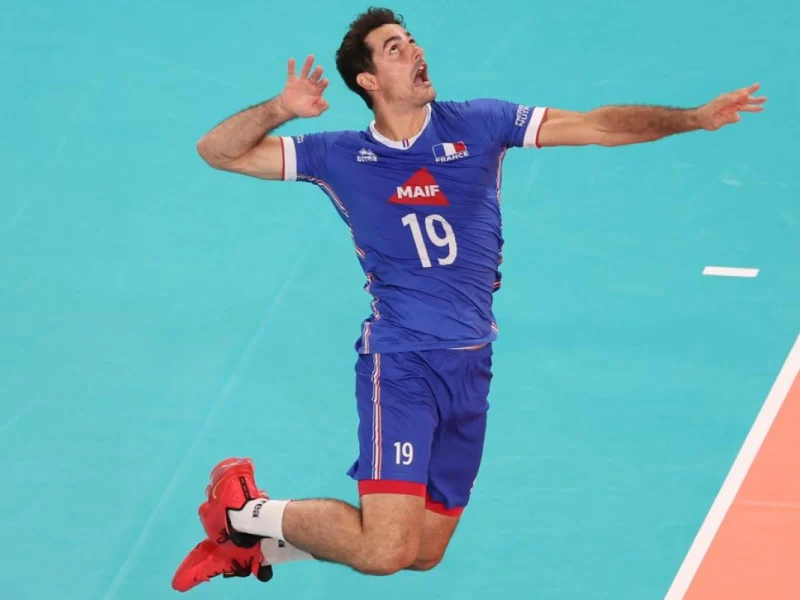 Yacine Louati jumps to attack for France during international volleyball.